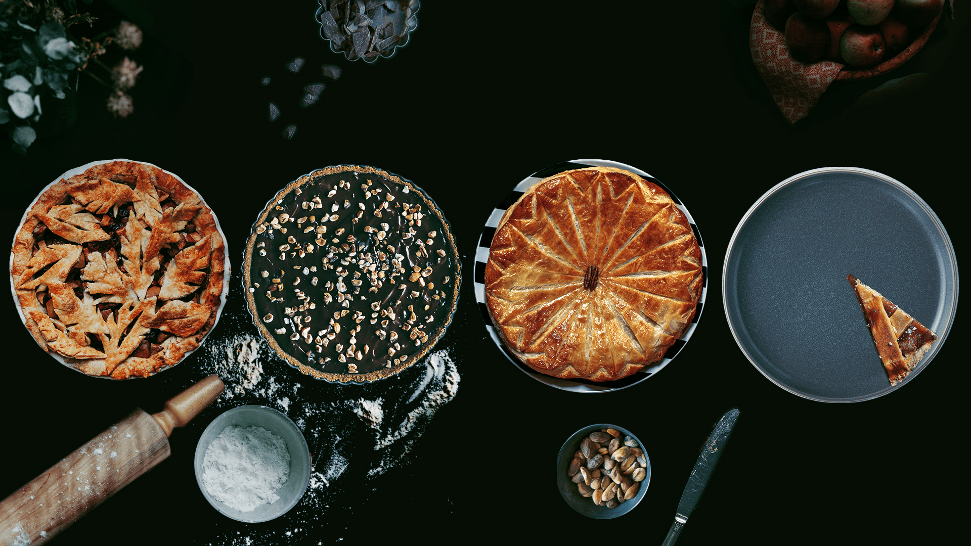 four pies, rolling pin, table with flour